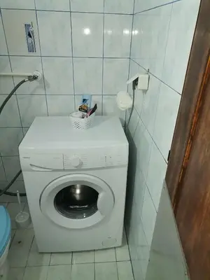 a small bathroom with a washing machine in it at Mala Sirena in Bukorovac