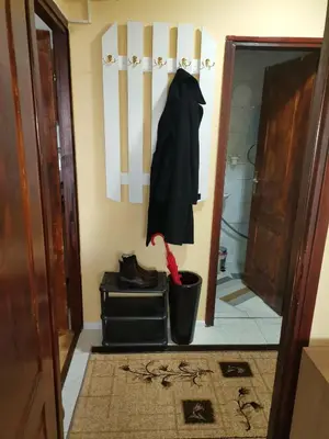 a black coat hanging on a wall in a hallway at Mala Sirena in Bukorovac