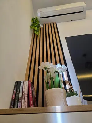 a book shelf with books and flowers on it at Panoramic Nest in Vrnjačka Banja