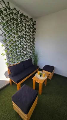 a living room with two couches and a table at Panoramic Nest in Vrnjačka Banja