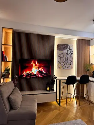 a living room with a fire in a fireplace at Studio Georgijev in Vrnjačka Banja