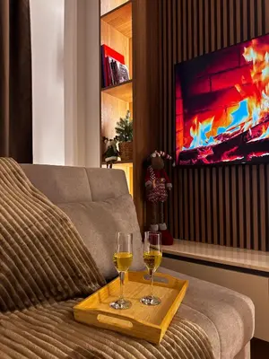 a living room with two glasses of wine on a table at Studio Georgijev in Vrnjačka Banja