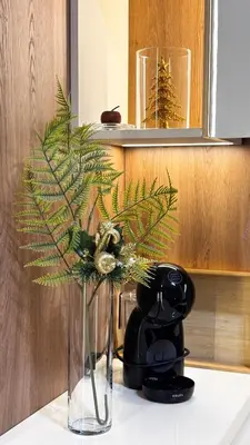 a vase with a plant in it on a counter at Studio Georgijev in Vrnjačka Banja