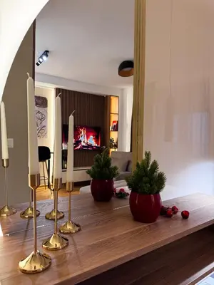 a living room with two potted plants on a table at Studio Georgijev in Vrnjačka Banja