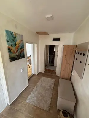 a living room with a hallway with a rug at Vilasukovo