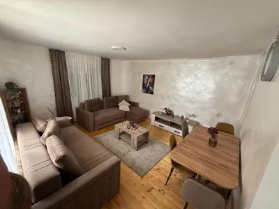 a living room with a couch and a table at Vilasukovo