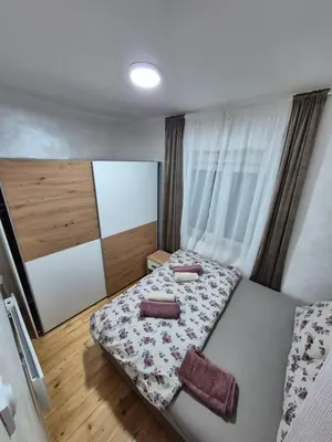 a bedroom with a bed with two pillows on it at Vilasukovo