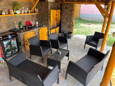 a patio with chairs and tables and a stove at Vilasukovo