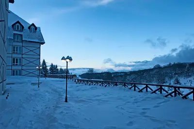a street light in the snow next to a building at Apartmani Kraljevi Čardaci in Kopaonik