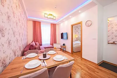 a living room with a table and a couch at Apartmani Kraljevi Čardaci in Kopaonik
