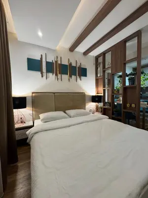 a bedroom with a large bed with white sheets at Mountain View President Kop in Kopaonik