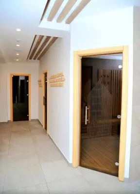 a hallway with a glass door in a building at Mountain View President Kop in Kopaonik