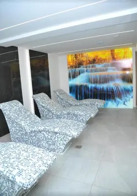 a group of chairs in a room with a painting at Mountain View President Kop in Kopaonik