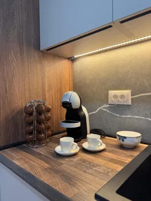 a coffee machine sitting on a counter with two cups at Mountain View President Kop in Kopaonik