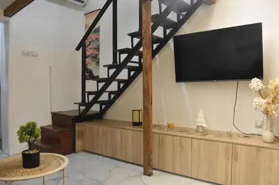 a living room with a flat screen tv on a wall at Fiko Apartment in Niš