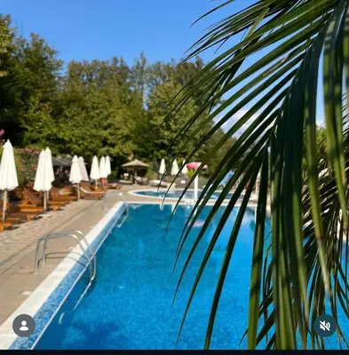 a view of a swimming pool with chairs and umbrellas at Apartman Đorđevic in Vrnjačka Banja