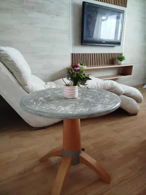 a table with a vase of flowers on it in a living room at Relax URBAN Life in Zaječar