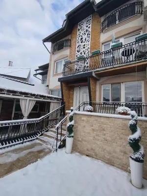 a house with snow in front of it at Relax URBAN Life in Zaječar