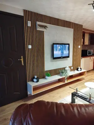 a living room with a flat screen tv on a wall at Relax URBAN Life in Zaječar