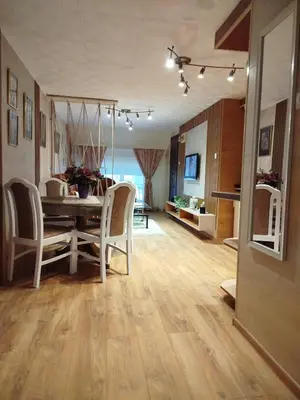 a dining room and living room with a table and chairs at Relax URBAN Life in Zaječar