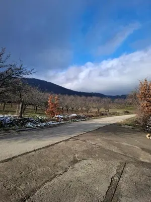 an empty road with a mountain in the background at Nature Nest Više Selo in Blace