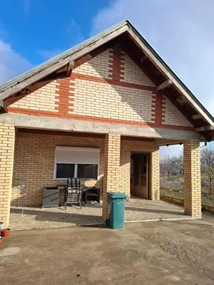 a small brick house with a large patio at Nature Nest Više Selo in Blace