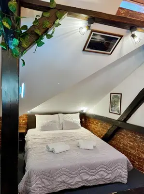 a bedroom with a bed with two towels on it at Hedonia Luxury Rooms in Pirot