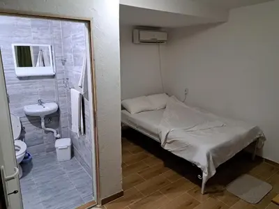 a small hospital room with a bed and a sink at Hostel Lalinac in Lalince