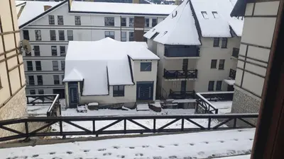 a view from a window of snow covered buildings at Zoned spa aparman in Kopaonik