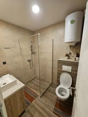 a bathroom with a shower and a toilet and a sink at Apartman AniLu Milmari Resort N40 in Kopaonik