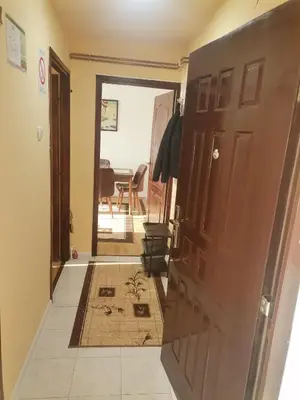 a hallway with an open door with a rug at Mala Sirena in Pirot