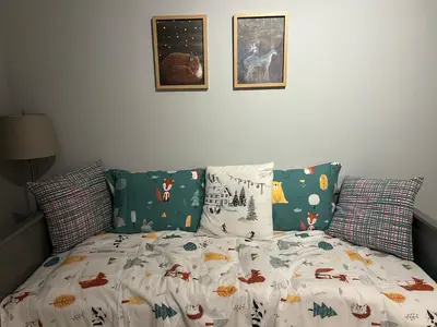 a bed with a comforter and pillows on it at Apartman Nikolic 417 in Kopaonik