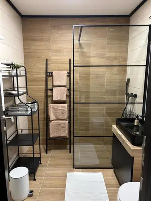 a bathroom with a glass shower and a sink at Apartman Nikolic 417 in Kopaonik