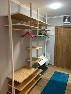 a room with wooden shelves and a blue rug at Apartman Nikolic 417 in Kopaonik