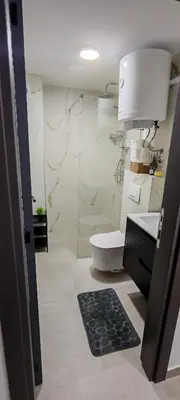 a bathroom with a toilet and a glass shower at Kopaonik Alibi25 in Kopaonik