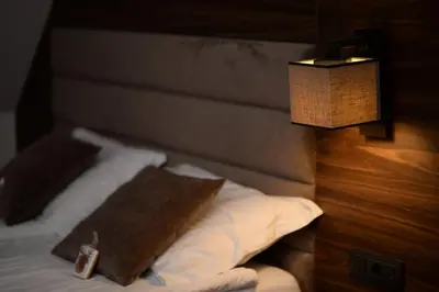 a bedroom with a bed with a pillow and a lamp at Deluxe Studio 19, Kula, Konaci, Kopaonik