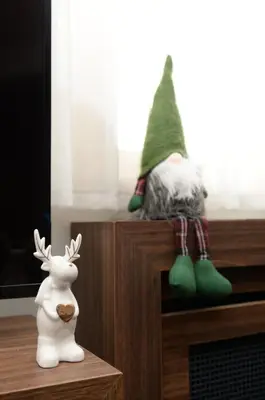 a figurine of a gnome sitting on top of a tv at Deluxe Studio 19, Kula, Konaci, Kopaonik