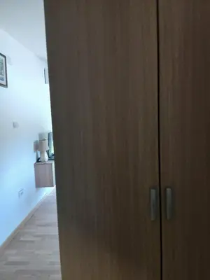 a wooden cabinet in a room with a hallway at Studio Carina in Soko Banja