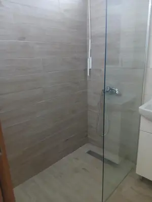 a bathroom with a shower with a glass door at Studio Carina in Soko Banja