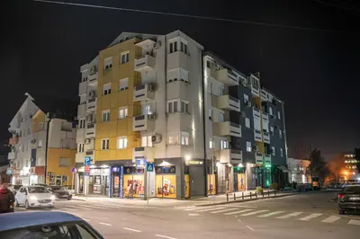 a large building on a city street at night at Apartman Nana in Vranje