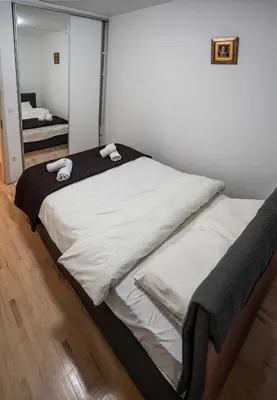 a bedroom with a bed with two towels on it at Apartman Nana in Vranje