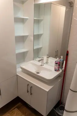 a white bathroom with a sink and a mirror at Apartman Nana in Vranje