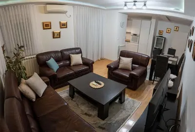 a living room with leather furniture and a table at Apartman Nana in Vranje