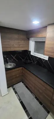 a small kitchen with a sink and a microwave at Pansion Mima in Niš