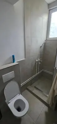 a bathroom with a toilet and a shower stall at Pansion Mima in Niš