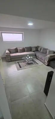 a living room with a couch and a table at Pansion Mima in Niš