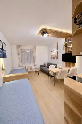 a living room with a couch and a table at Konaci Prime Center in Kopaonik