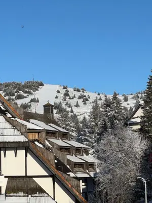 a building with snow covered roofs on a mountain at Konaci Prime Center in Kopaonik