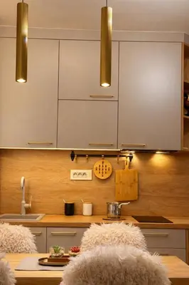 a kitchen with white cabinets and a wooden counter top at Konaci Prime Center in Kopaonik