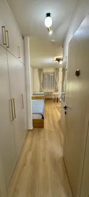 a small room with a bed and a hallway at Konaci Prime Center in Kopaonik